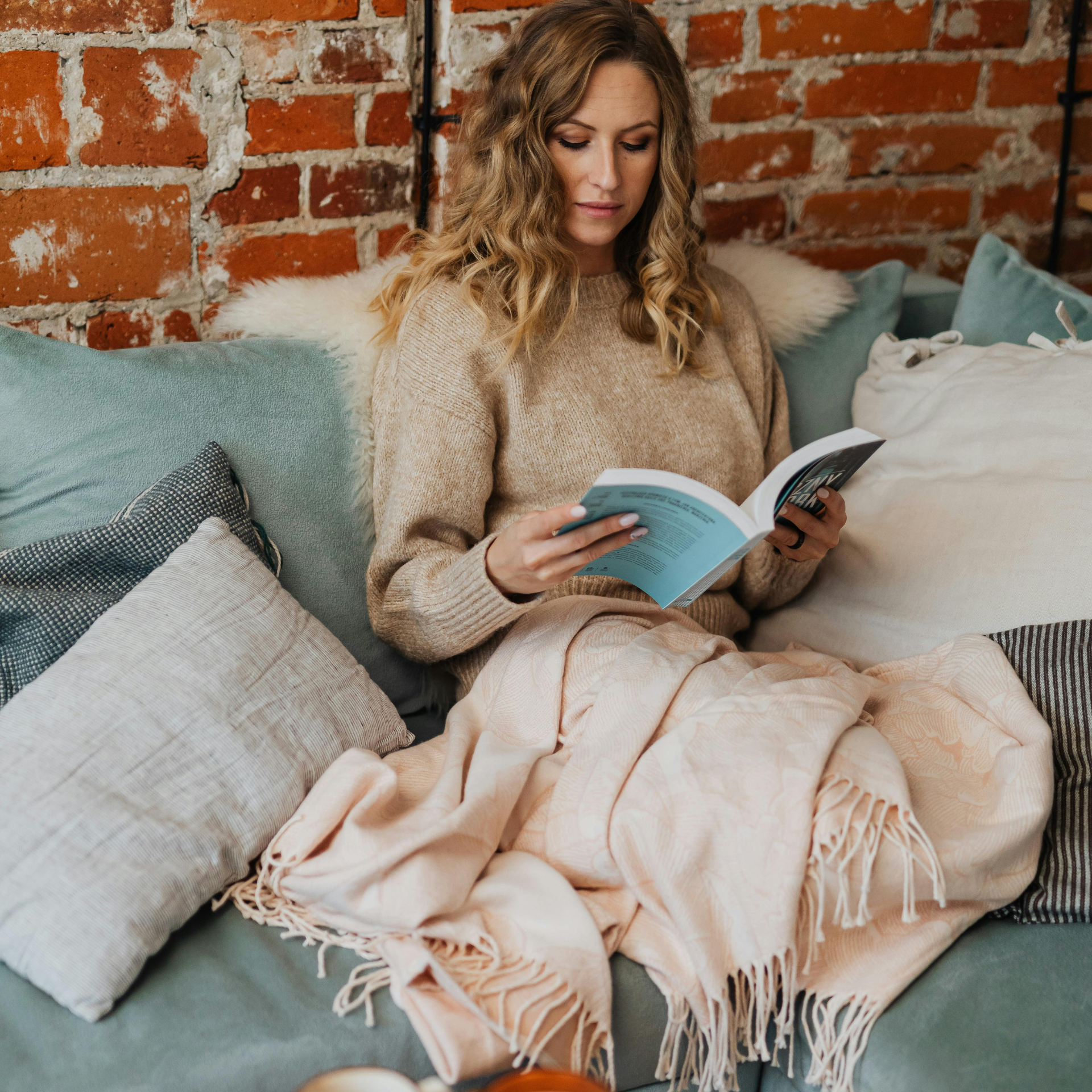 Working professional relaxing and reading at home after hiring a house cleaning service in Collin County and Dallas County, TX
