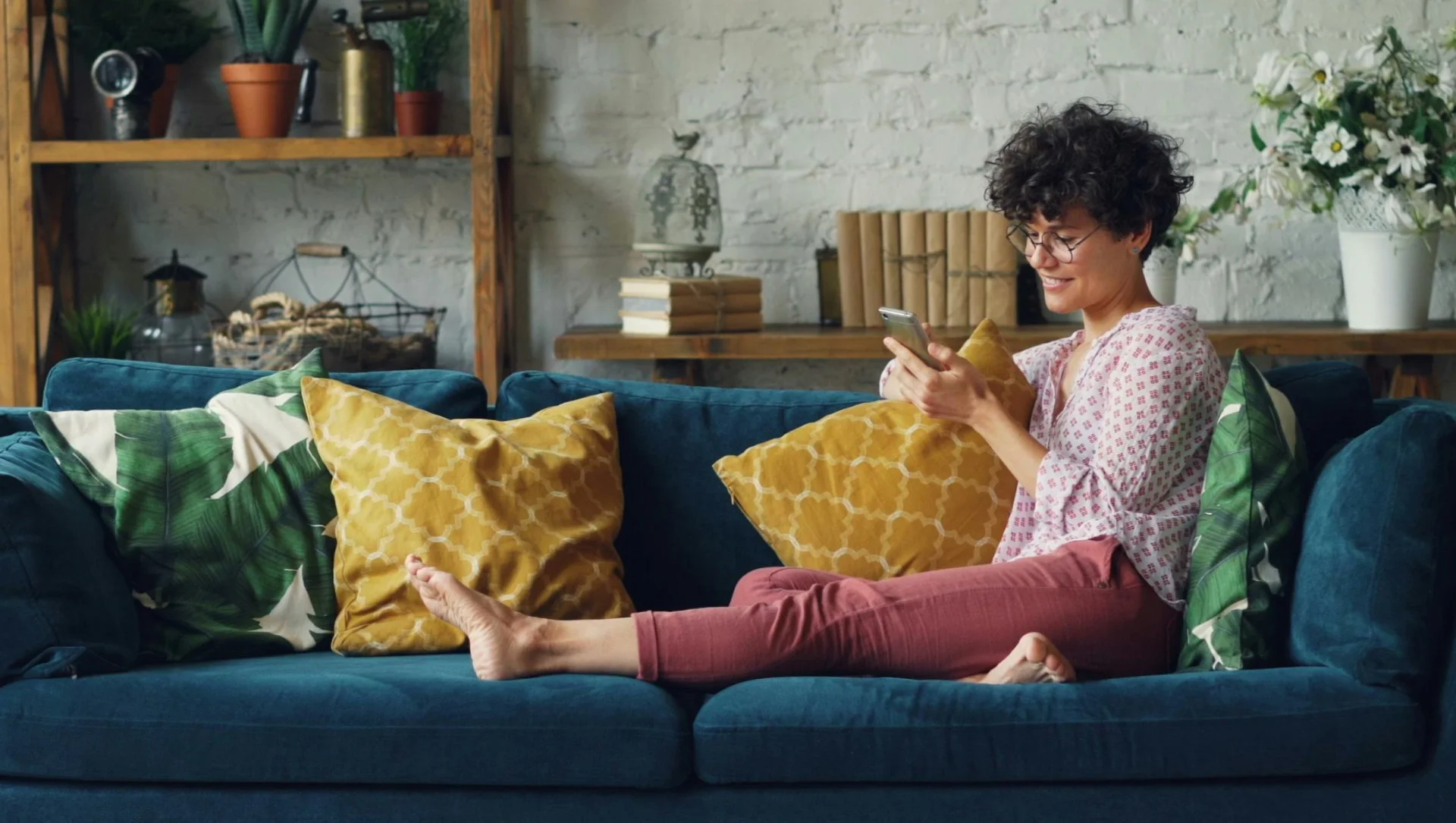 Woman relaxing on her phone at home after recurring house cleaning in McKinney Texas